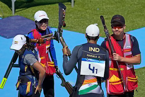 Lyu Jianlin is congratulated by India's Amanjeet Singh Naruka